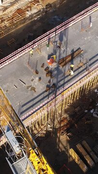 Vertical Video of Construction Workers in the Roof of New Building 