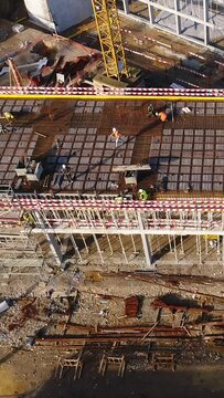 Vertical Video of Construction Workers in the Roof of New Building 