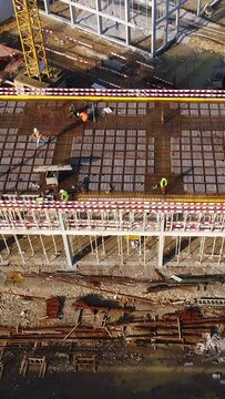 Vertical Video of Construction Workers in the Roof of New Building 