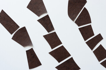 brown paper stripes arranged diagonally on white (composed of many polygon forms)