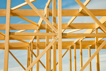 construction of a building made of wood in the background blue sky