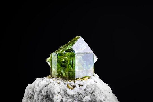 green Fluorapatite isolated on black background. macro detail close-up rough raw unpolished semi-precious gemstone.