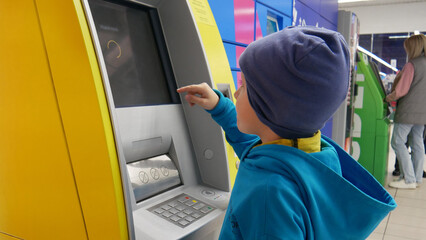 Close-up of a child using the ATM