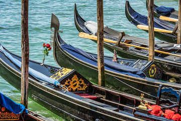 Fototapeta na wymiar Colorful picture with gondolas moored on Grand Canal near Saint Mark square, in Venice Italy.