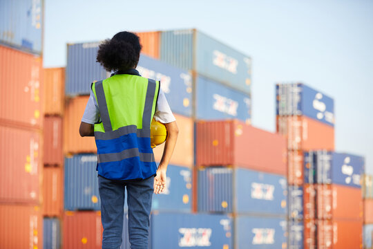 Back View Factory Worker Or Engineer Holding Helmet And Looking Forward In Containers Warehouse Storage