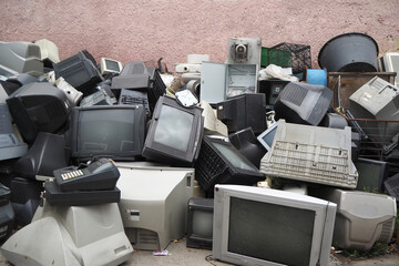 Electronic waste. Out of use monitors and televisions. Recycling industry. Mixed-plastic waste in...
