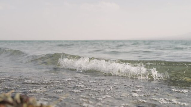 Slow motion closeup shot of clear water waves of a lake