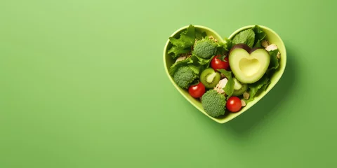 Fotobehang Healthy and healthy diet food in a heart-shaped plate. Banner. © Татьяна Прокопчук