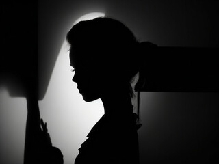 "Hidden Beauty: Closeup Portrait Silhouette of Stunning Woman in Shadow - Illuminated by Light, Creating a Sensual and Mysterious Atmosphere for a Fashion Concept."
