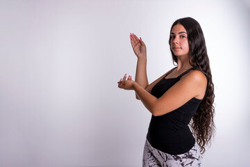 "Young Caucasian Woman Gesturing to the Left While Directly Engaging with the Camera, Providing Visual Guidance and Directing Attention."