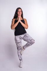 "Young Caucasian Woman Engaging in Serene Yoga Practice with Graceful Postures, Against a Clean and Tranquil White Background, Fostering Physical and Mental Well-being."