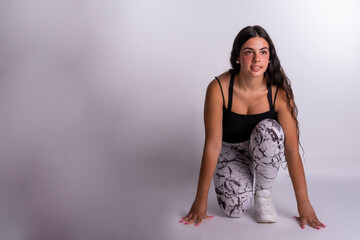 "Young Caucasian Woman Eagerly Preparing Herself to Embark on a Jogging Adventure, Gazing Intently at the Camera with a Determined Expression."
