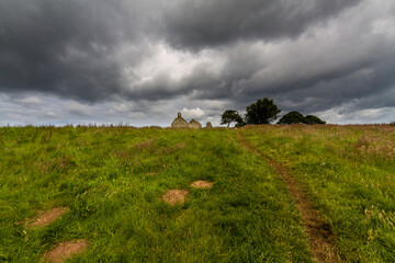 Beautiful old welsh chapel or church, ruin, moody sky as copyspace top. - 654997634