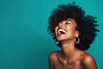 A joyful black woman with her mouth wide open in laughter, expressing pure happiness.