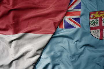 big waving realistic national colorful flag of indonesia and national flag of Fiji .