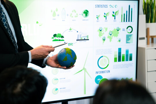 Businessman leader give presentation on eco-friendly implementation in order to reduce CO2 emission and make sustainable ecology for greener future with corporate environmental regulation. Quaint