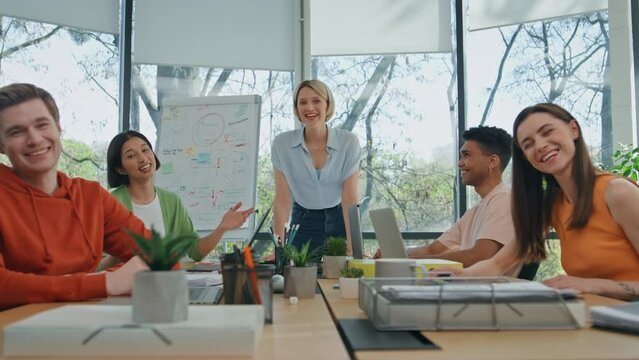 Laughing colleagues video conferencing office pov. Diverse team remote meeting