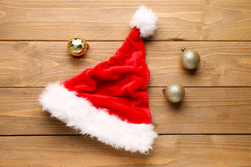 Obraz na płótnie Canvas Santa hat with Christmas toys on wooden table