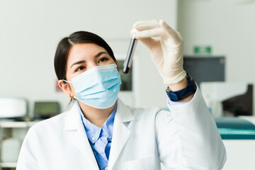 Beautiful chemist doing medical test with blood samples