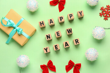 Different Christmas decor and text HAPPY NEW YEAR on green background