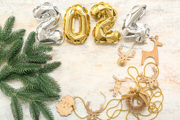 Frame made of foil balloons, Christmas decorations and fir branches on light background