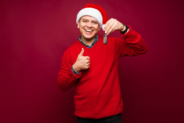 Fototapeta premium Attractive cheerful man buying a car on christmas