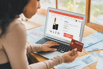 Woman shopping online on internet marketplace browsing for sale items for modern lifestyle and use credit card for online payment from wallet protected by crucial cyber security software - obrazy, fototapety, plakaty