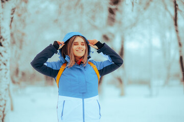 Happy Woman Enjoying Winter Having Fun Outdoors. Cheerful carefree tourist enjoying wintertime in...