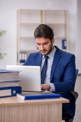 Young male employee working in the office