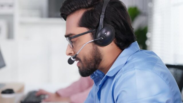 Closeup face of indian or arabian man wearing headset and talking, business advisor, call center worker, company representative, support service operator, holds online consultation