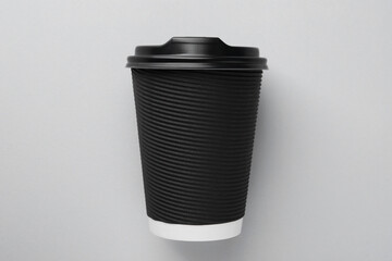 One paper cup on light grey background, top view. Coffee to go