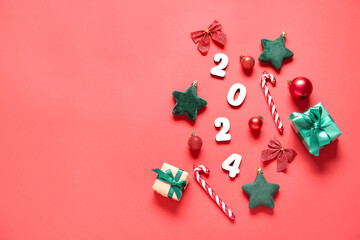 Figure 2024 with Christmas decorations and gift boxes on red background
