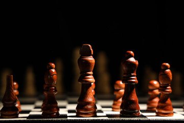 Game board with chess pieces on dark background, closeup