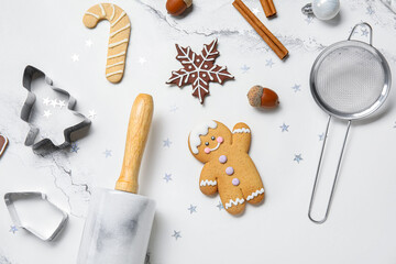 Fototapeta na wymiar Christmas gingerbread cookies, baking molds and rolling pin on white grunge background