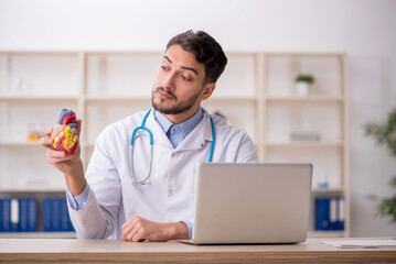 Young male doctor cardiologist working in the clinic