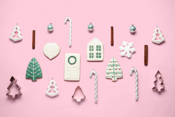 Composition with different Christmas cookies, decorations and cutters on pink background