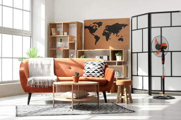 Interior of stylish living room with electric fan, sofa and table