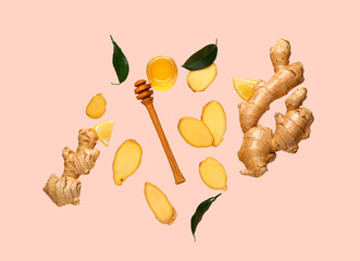 Flying slices of fresh ginger root and jar with honey on pink background - Powered by Adobe