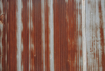 An old rusty metal sheet roof textured. Rust is an iron oxide formed by the reaction of iron and oxygen in the catalytic presence of water or air moisture. - obrazy, fototapety, plakaty