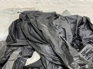 Big pile of black tarpaulin