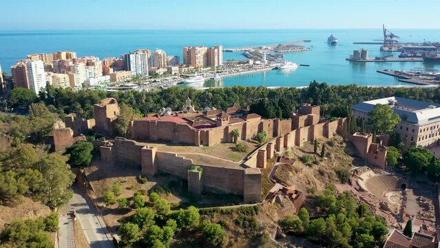 Aerial 4K video from drone to Alcazaba and Castle of Gibralfaro in the background a panoramic view of the city of Malaga and old town Malaga at sunset. Malaga,Costa del sol, Andalusia,Spain, (Series)