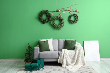 Interior of stylish room decorated for Christmas celebration with hanging wreaths
