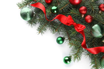 Fir branches with colorful Christmas balls and bow on white background