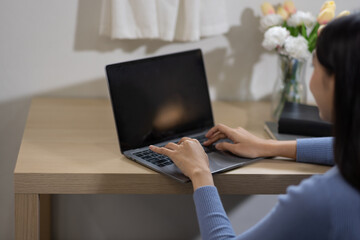 
Woman using laptop, indoors calling watching elearning webinar. 