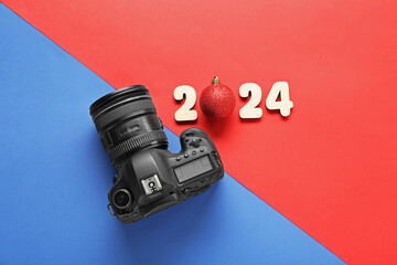 Figure 2024 with Christmas ball and photo camera on colorful background