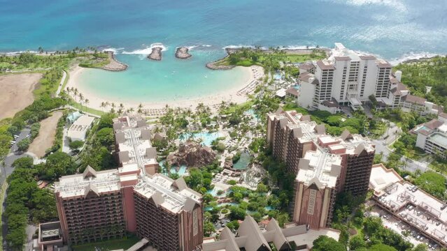 Top down on Ko Olina resorts on Oahu island Hawaii USA tourism. Palm trees exotic travel paradise 4K. Cinematic aerial luxury beachfront hotel. Drone view family hotel with scenic blue beach lagoon