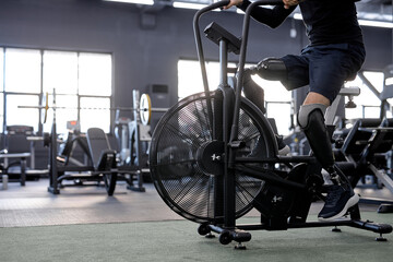 artificial legs pedaling at gym, close up cropped side view shot