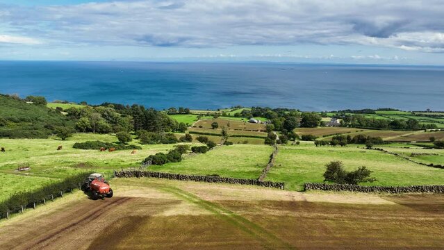 Aerial Video of Massey Ferguson 390T Tractor and Abbey Tanker spreading manure slurry in a field on a farm in UK  09-09-23
