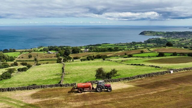 Aerial Video of Massey Ferguson 390T Tractor and Abbey Tanker spreading manure slurry in a field on a farm in UK  09-09-23
