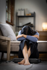 Fototapeta premium Unhappy lonely depressed Upset woman at home, she is sitting on the couch at home, feeling despair and anxiety, loneliness, having psychological trouble depression concept